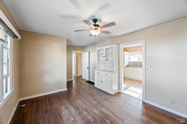 spare room with ceiling fan and dark hardwood / wood-style flooring