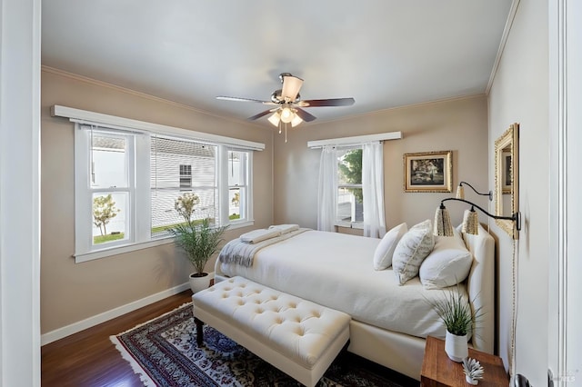 bedroom with crown molding, wood finished floors, baseboards, and a ceiling fan