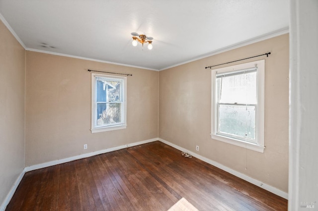 empty room with crown molding, dark wood-type flooring, and a healthy amount of sunlight