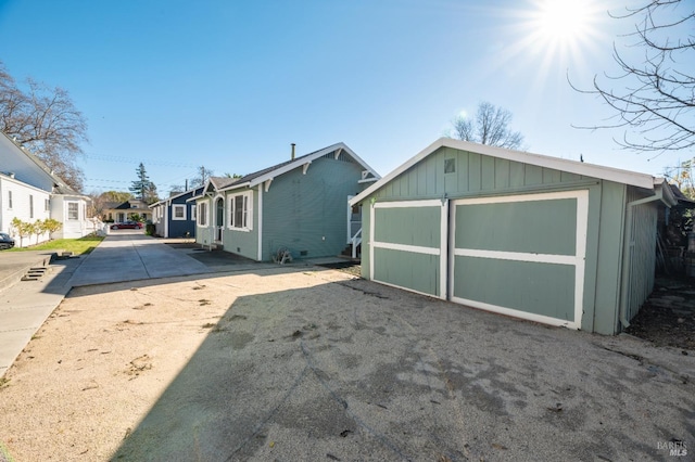 exterior space with an outbuilding and a garage