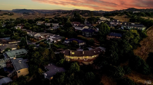 aerial view at dusk featuring a mountain view