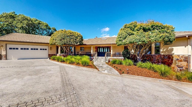 view of front of property with a porch and a garage