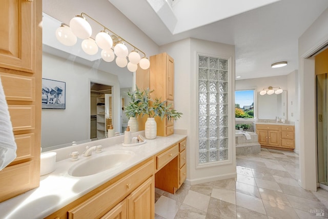 bathroom featuring vanity, tile patterned flooring, and a tub