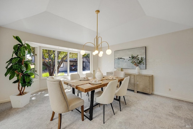 carpeted dining area featuring a notable chandelier and vaulted ceiling