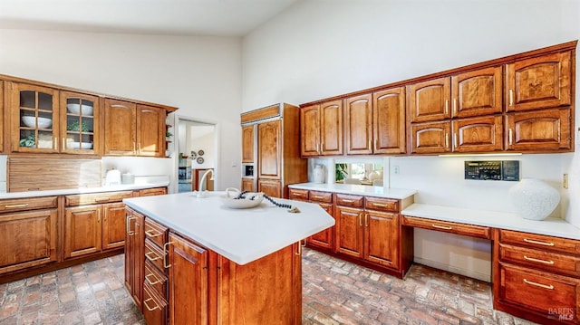 kitchen with high vaulted ceiling and a center island