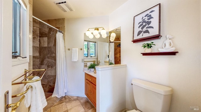 bathroom with walk in shower, vanity, and toilet