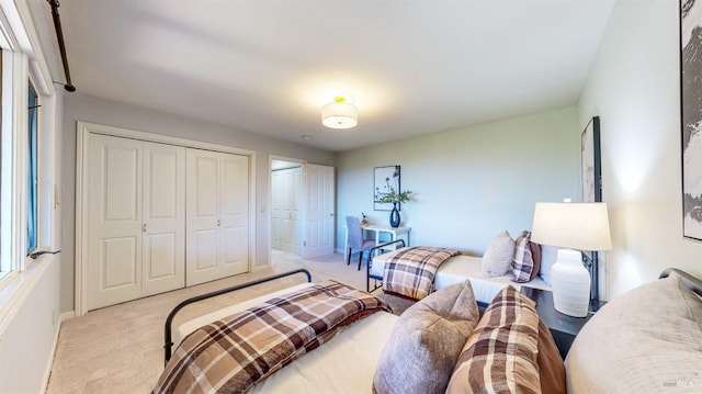 bedroom with light colored carpet and a closet