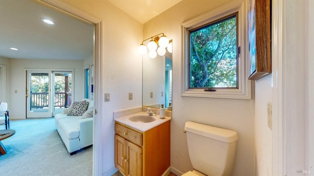 bathroom with plenty of natural light, vanity, and toilet