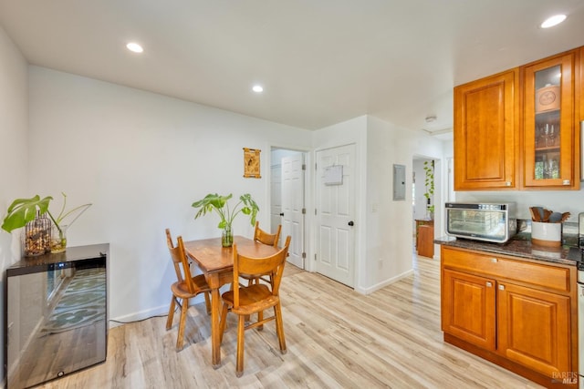 dining space with light hardwood / wood-style floors and electric panel