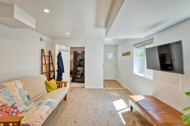 carpeted living room with stacked washer / dryer