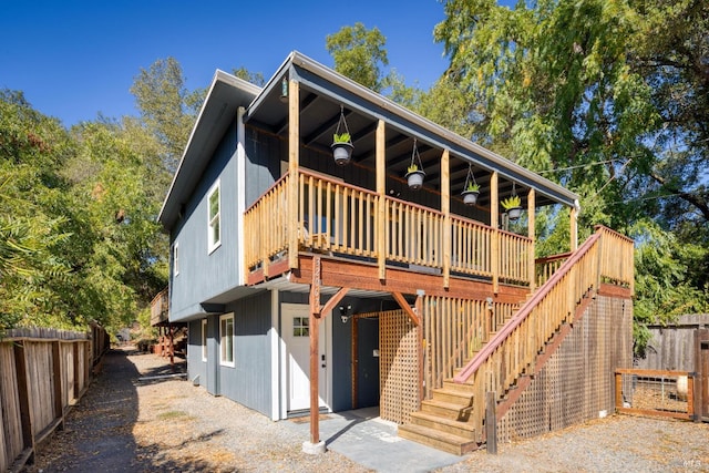 rear view of house featuring a deck