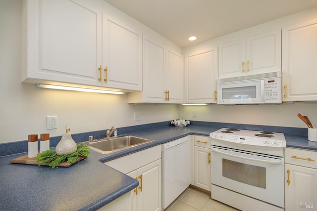 kitchen with sink, light tile patterned floors, white cabinets, and white appliances