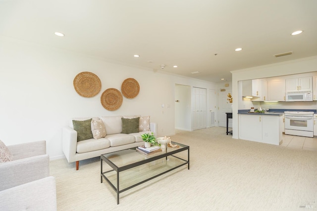 living room with crown molding and light carpet