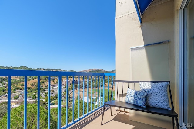 balcony featuring a water and mountain view