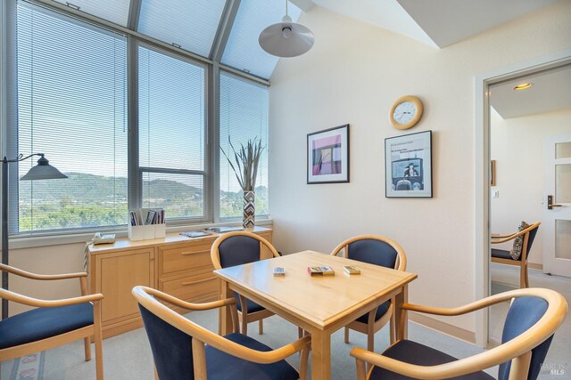 dining space featuring lofted ceiling