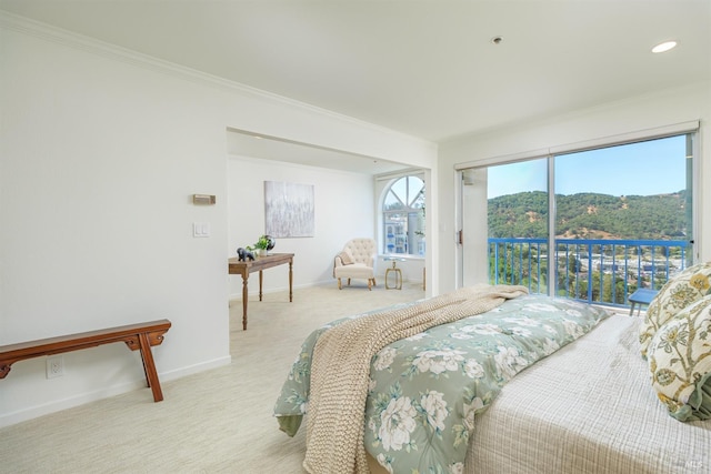 carpeted bedroom featuring ornamental molding, a mountain view, and access to outside