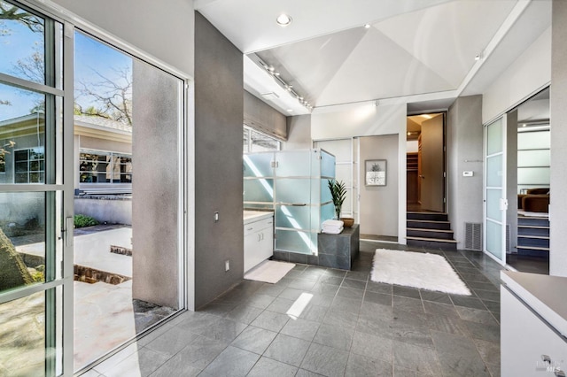 bathroom with lofted ceiling and tile patterned flooring