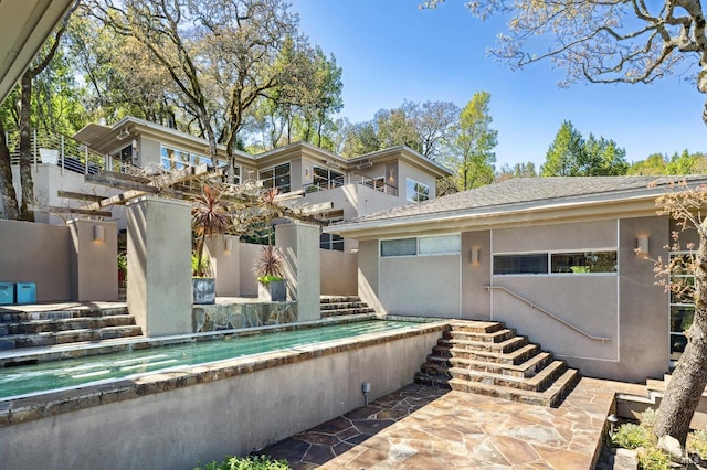 back of house with a patio