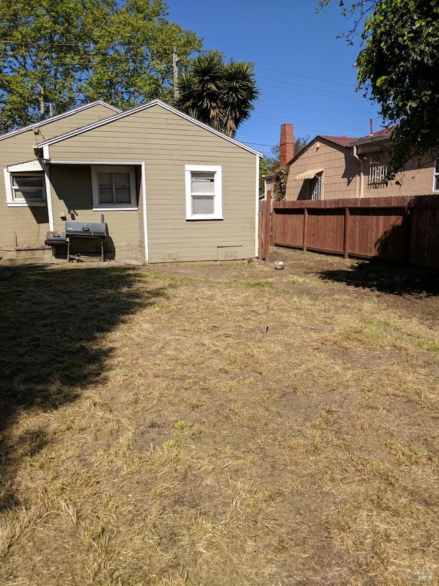 exterior space featuring a lawn and fence