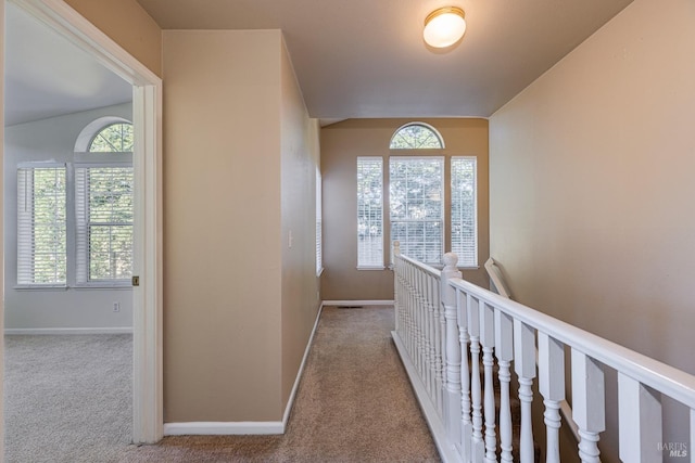 hall featuring light colored carpet