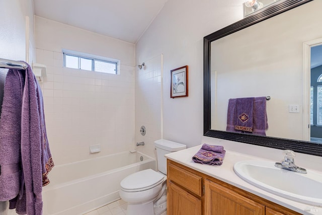 full bathroom with tiled shower / bath, vanity, and toilet