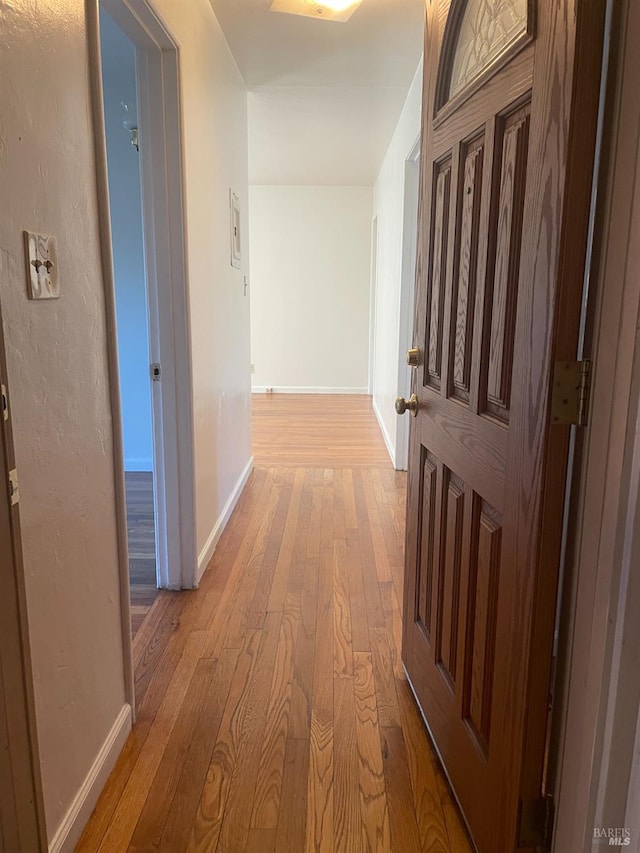 hall with light hardwood / wood-style floors