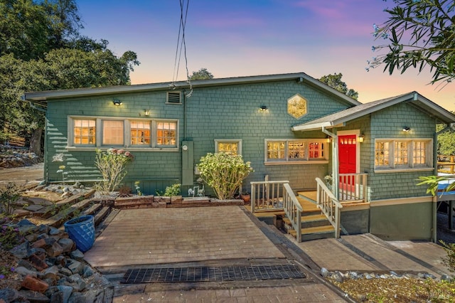 back of house featuring a wooden deck