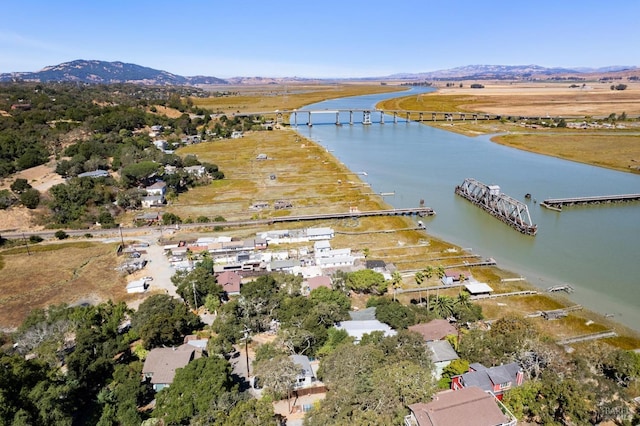 drone / aerial view featuring a water and mountain view