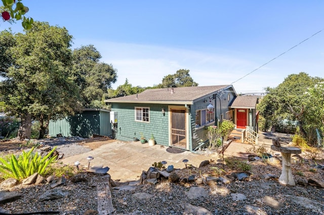 view of front of home with entry steps and a patio area