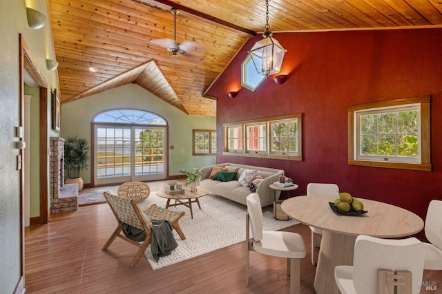 living room featuring high vaulted ceiling, wooden ceiling, wood finished floors, and baseboards