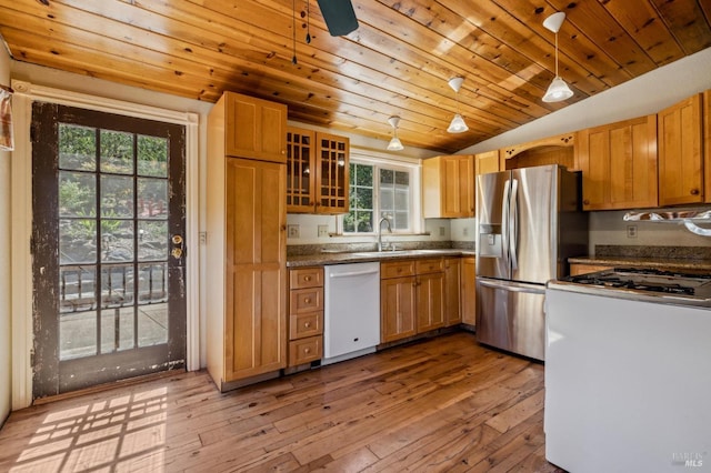 kitchen featuring pendant lighting, light wood finished floors, a sink, white dishwasher, and stainless steel fridge with ice dispenser