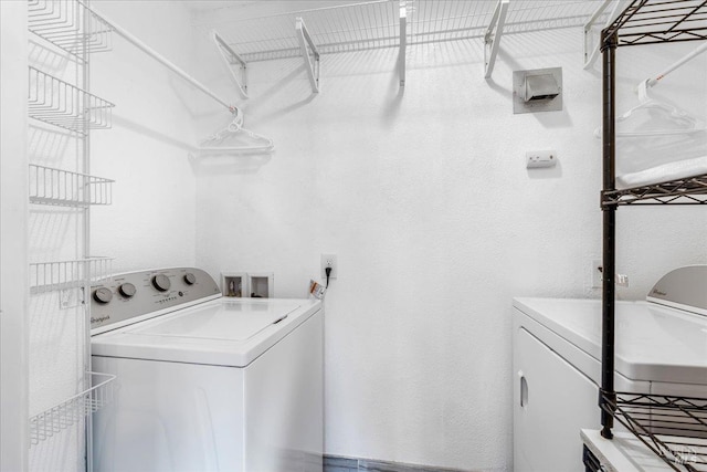 laundry room with washing machine and clothes dryer