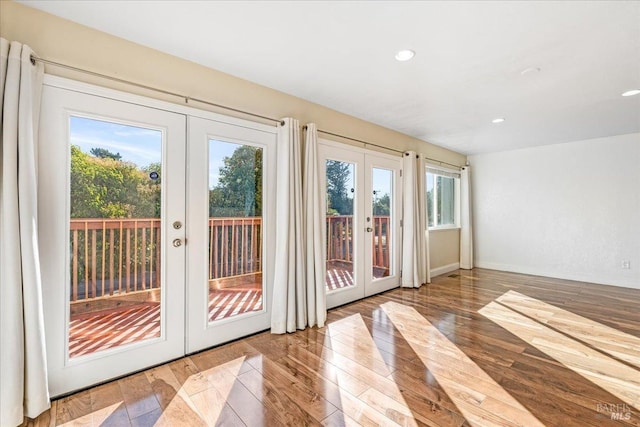 doorway to outside with french doors and wood-type flooring