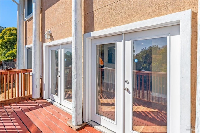 entrance to property featuring french doors and a deck