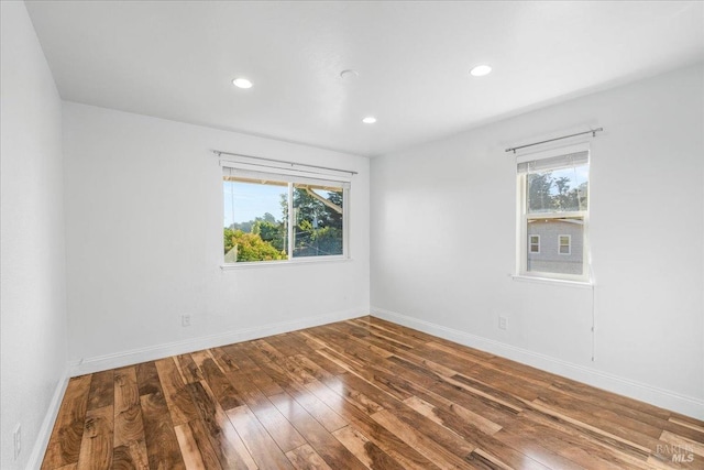 empty room with hardwood / wood-style floors