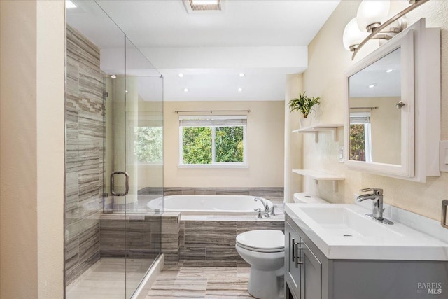 full bathroom featuring vanity, independent shower and bath, and toilet