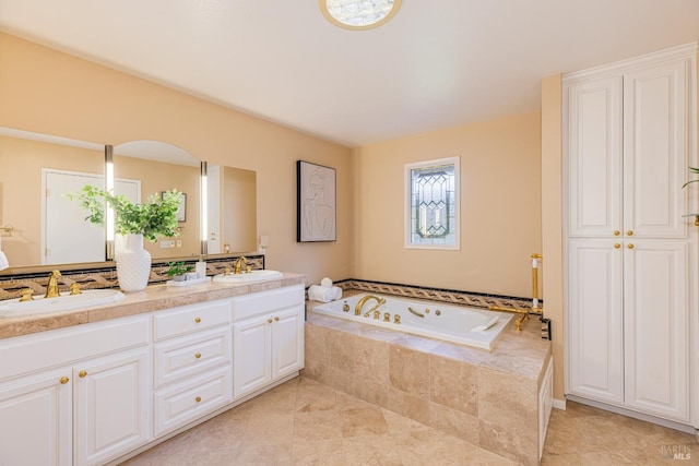 bathroom featuring vanity, tile patterned flooring, and tiled tub