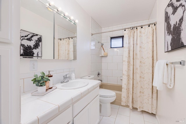 full bathroom featuring shower / bath combo with shower curtain, tile patterned floors, toilet, and vanity