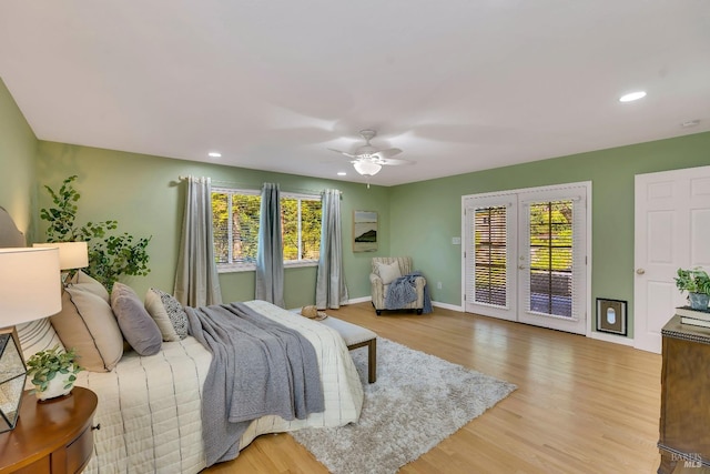 bedroom with ceiling fan, hardwood / wood-style flooring, and multiple windows