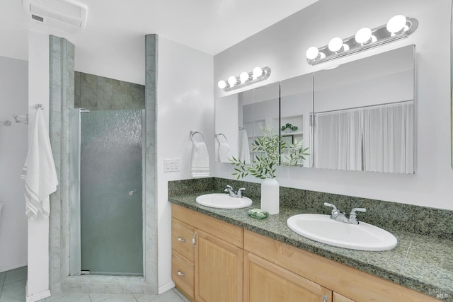 bathroom with vanity, tile patterned floors, and a shower with door