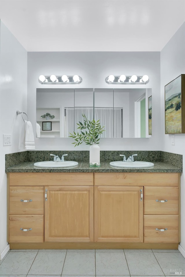 bathroom with tile patterned flooring and vanity