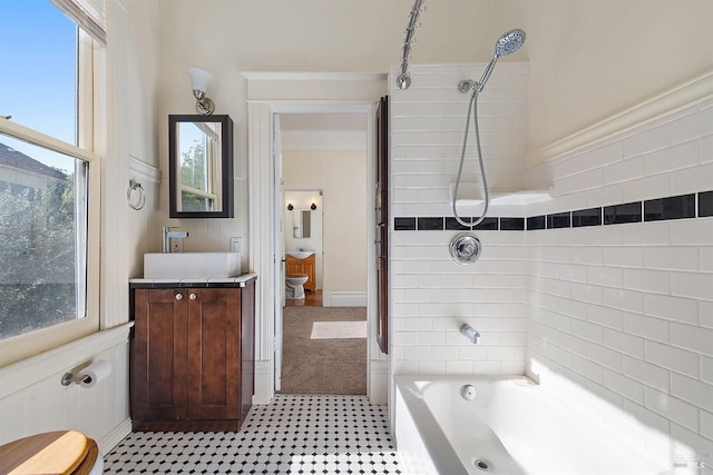 full bathroom with vanity, toilet, and tiled shower / bath combo