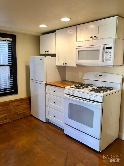 kitchen with white appliances and white cabinets