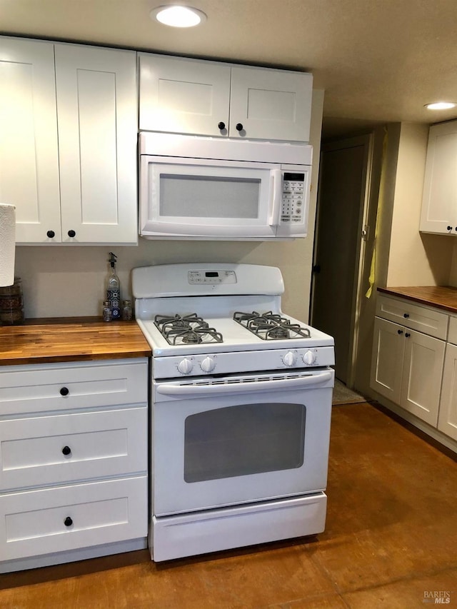 kitchen featuring butcher block counters, white appliances, and white cabinets