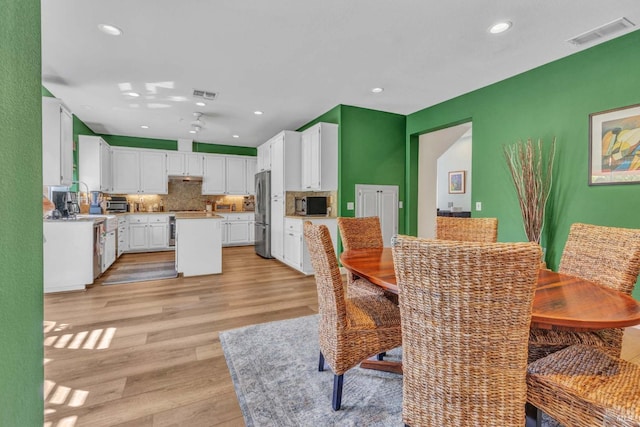 dining room with light wood-type flooring