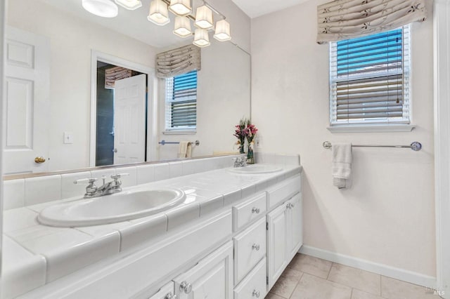 bathroom with tile patterned flooring, vanity, and a chandelier