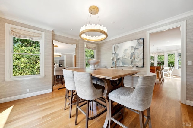 dining room with baseboards, a notable chandelier, crown molding, and light wood-style floors
