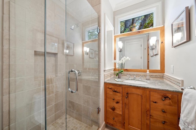 bathroom featuring crown molding, vanity, and an enclosed shower