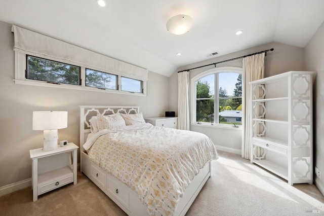 bedroom with lofted ceiling and light colored carpet