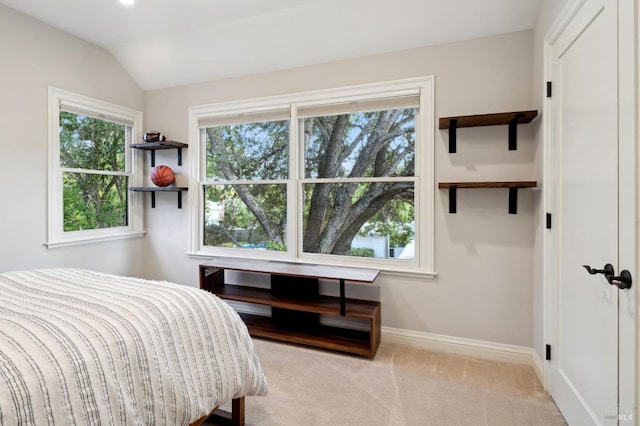 bedroom featuring lofted ceiling and light colored carpet